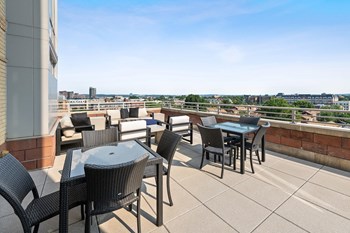 Tabes and chairs on rooftop terrace at Bradley Braddock Road Station Apartments in Alexandria VA